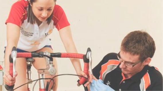 Athlete Cyclist monitoring training performance with sports scientist