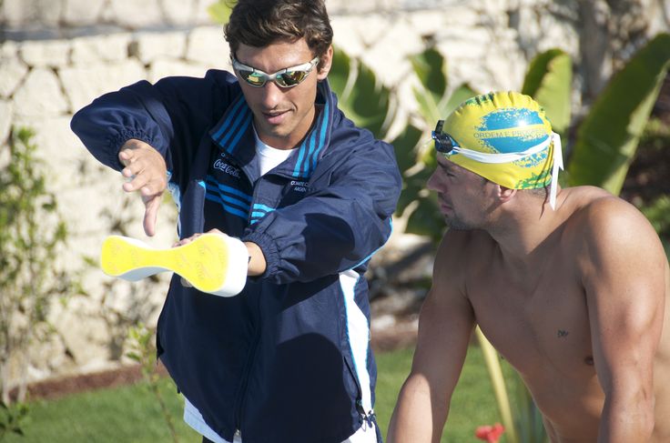 Triathlon Coach discussing performance with athlete swimmer