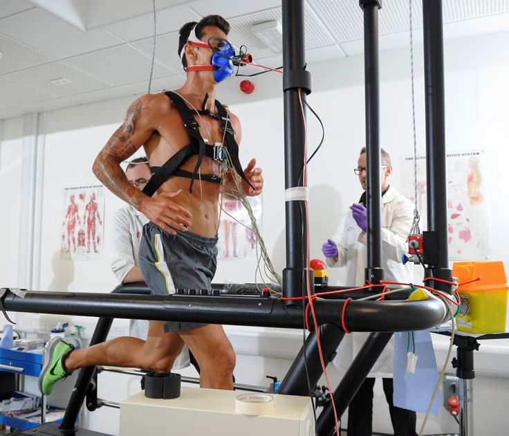 Sports Scientist Monitoring Performance on athlete runner