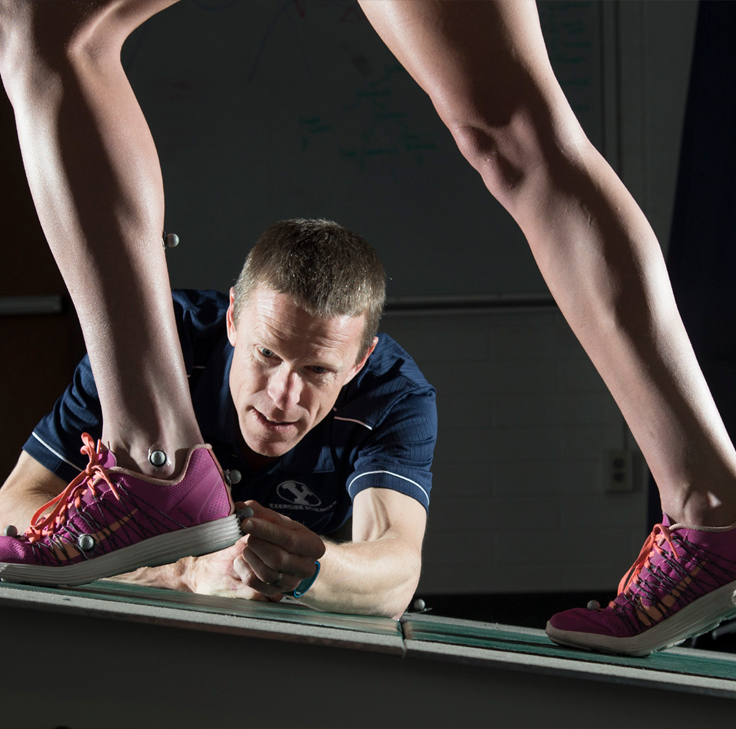 Sports Scientist Monitoring Performance of athlete runner