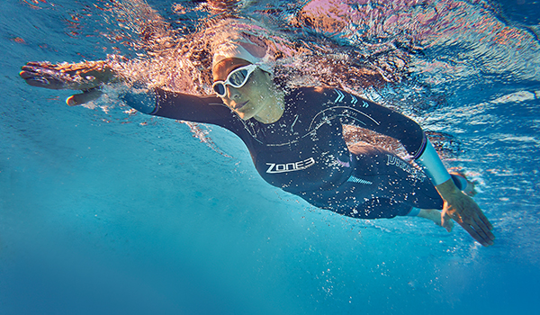 Athlete swimmer swimming underwater as part of a race