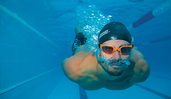 Athlete swimmer swimming underwater during race