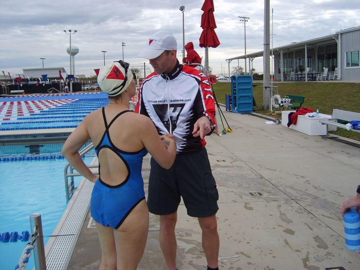 Swimming Coach discussing performance with athlete swimmer