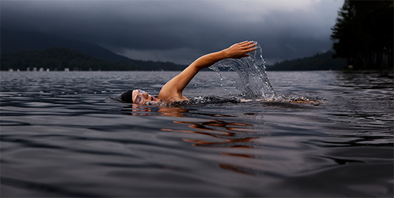 Athlete swimmer swimming in ocean as part of triathlete race