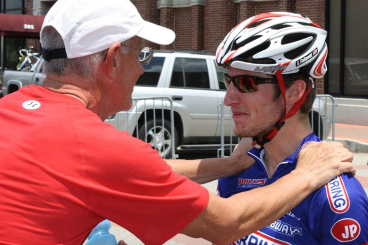 Coach supporting Athlete cyclist before Triathlon race