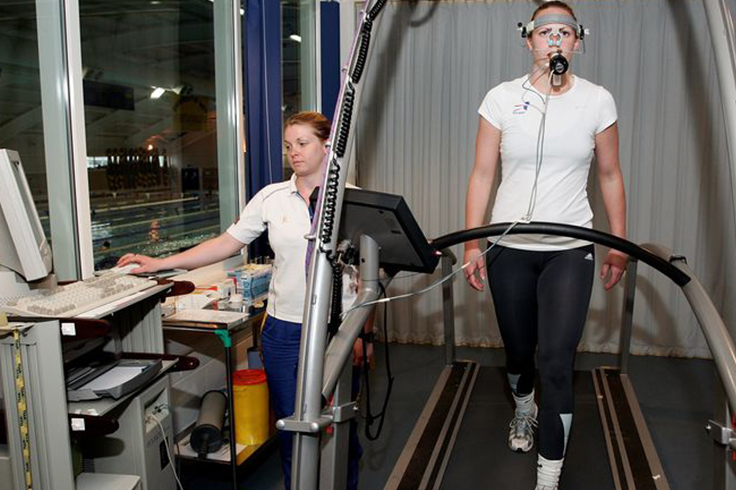 Althlete breathing patterns being measured by sports scientist